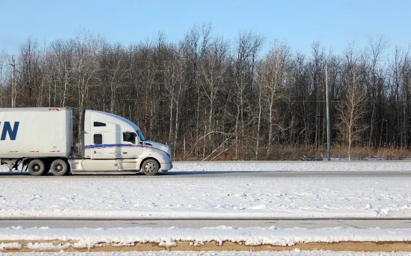 Refrigerated semi truck driving on highway for temperature-controlled transport Refrigerated semi truck driving on highway for temperature-controlled transport